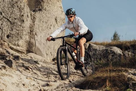 Equipped Professional Cyclist Descends a Slope on His Mountain Bike, Sportsman Stock Photos