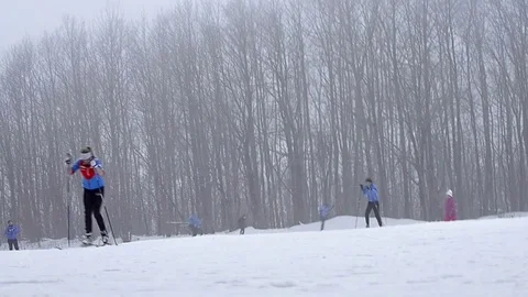 Equipped skiers skiing on piste Stock Footage 74763473