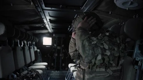 Equipped special forces soldier in an armored military vehicle Stock Footage 327353768