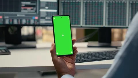 Equity analyst using green screen smartphone to reviews quarterly earnings Stock Photos