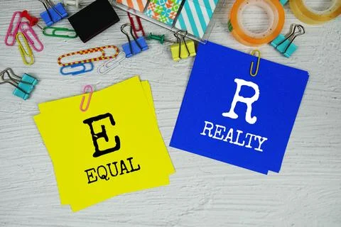 ER - Equal Realty text on stick note with stationery on concrete background Stock Photos