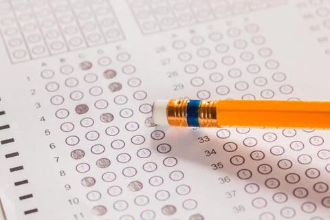 Erase wrong answer on exam carbon paper computer sheet and pencil Stock Photos