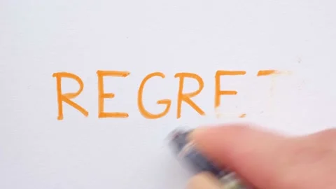 Erasing handwritten word Regret. Stock Footage 132303467