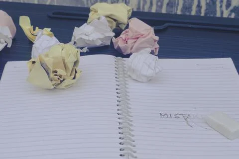 Erasing Mistake on notepad. Learning, wrong, blooper, regret sayings backgrou Stock Photos