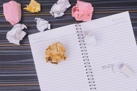 Erasing Mistake on notepad. Learning, wrong, blooper, regret sayings backgrou Stock Photos