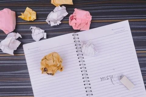 Erasing Mistake on notepad. Learning, wrong, blooper, regret sayings backgrou Stock Photos