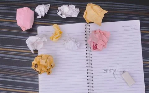 Erasing Mistake on notepad. Learning, wrong, blooper, regret sayings backgrou Stock Photos