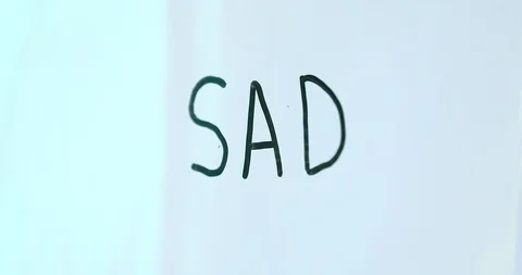 Erasing SAD word on white board Stock Footage 102613533