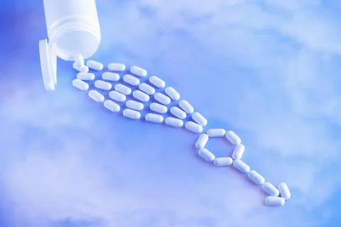 Erectile dysfunction therapy medical concept. Pills are poured out of a bottle Stock Photos