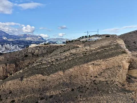 Erecting structures on steep rocky cliffs overlooking vast ocean with safety Stock Photos
