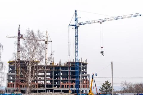 Erection of a monolithic part of the building frame structure using tower cra Stock Photos