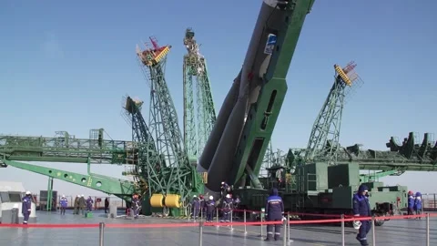Erection of Russian Soyuz rocket into upright position at Baikonur launchpad Stock Footage 273698117