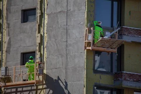 Erector installing on wall insulation material Stock Photos