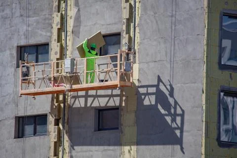 Erector installing on wall insulation material Stock Photos