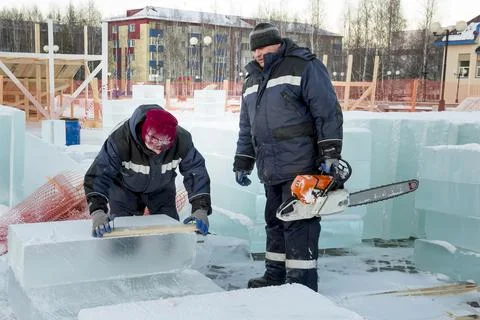 Erectors marking ice blocks at a construction site 写真素材