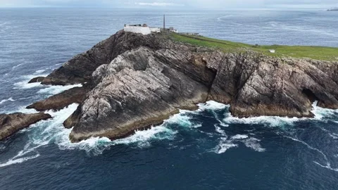 Erial drone view approaching a historic lighthouse, Ireland. Stock Footage 345814342
