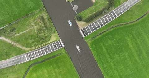 Erial drone views of an aqueduct in the province of Friesland with a road Video stock 249557464