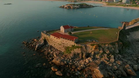 Erial view of a historic stone hermitage perched on a rugged coastal promontory 库存影片 336287376