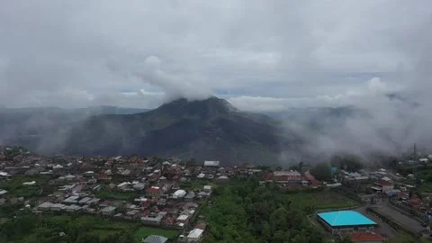 Erial View of Misty Mount Batur Volcano and Kintamani Village in Bali Indonesia Stock Footage 315435369