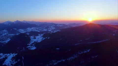 Erial view of the sunset in a beautiful mountain winter landscape Stock Footage 234991547