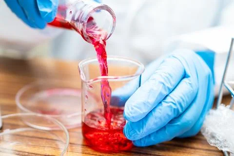Erlenmeyer flask, conical flask glassware with red color liquid solution in.. Stock Photos