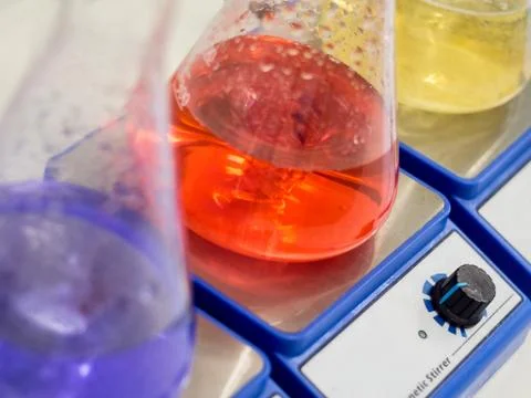 Erlenmeyer flasks with colorful solutions closeup Stock Photos