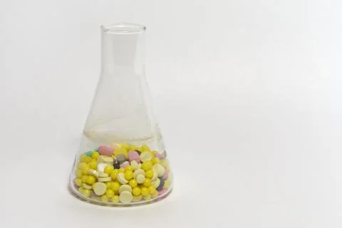 Erlenmeyer flasks, filled with tablets and pills Stock Photos