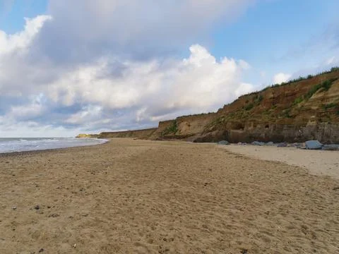 Eroded cliffs on Happisburgh beach in the early evening light Foto stock