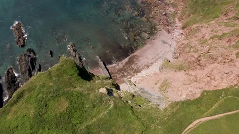 Eroded Cliffs, Rocky Shore &amp; Blue Clear Ocean - Aerial Drone Footage Stock Footage 160101460
