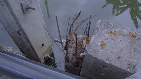Eroded Electric Pole Base in Water Stock Footage 338342981