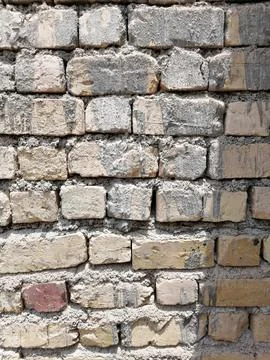 Eroded elegance of a brick wall Stock Photos
