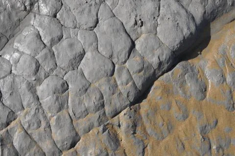 Eroded grey rock texture with some sand Stock Photos