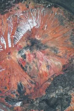 Eroded industrial slagheap surface with deep gullies and mineral strata Stock Photos