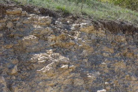 Eroded Limestone Cliff with Grass Top Stock Photos