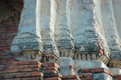 Eroded red bricks and white pillars in a buddhist temple. Stock Photos
