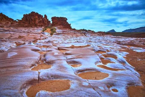 Eroded Red Sandstone Formations and Desert Landscape Under Vibrant Blue Sky Stock Photos