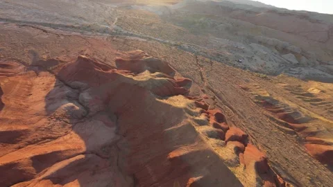 Eroded red sandstone formations creating a colorful landscape in the desert Video stock 308950926