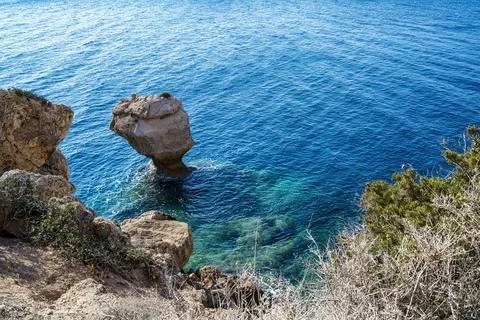 Eroded Rock Formation in Clear Blue Sea 스톡 사진