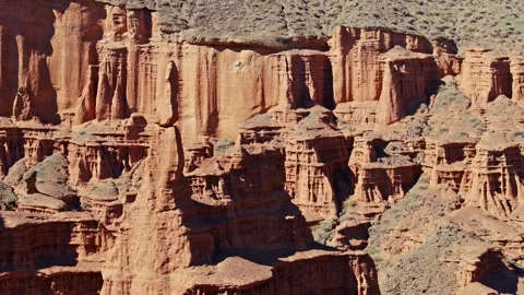 Eroded rock formations in the desert landscape of Kyrgyzstan, orbiting drone Stock Footage 331463314