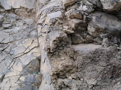 Eroded Rock Surface with Cracks and Layers of Sediment Stock Photos