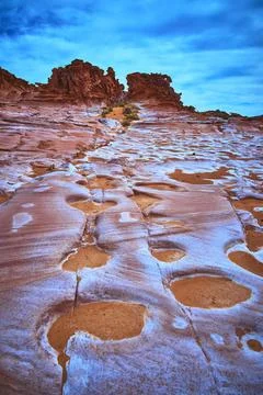 Eroded Sandstone Formations and Vibrant Desert Colors Under Dramatic Blue Sky Stock Photos
