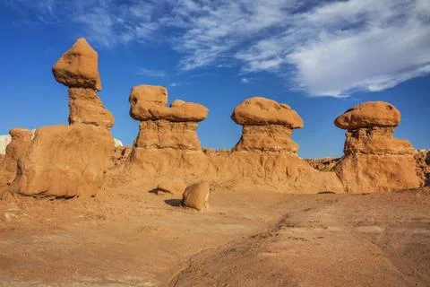 Eroded sandstone hoodoo rock formations under a bright blue sky with scatte.. Stock Photos