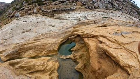 Eroded Sandstone Pool in Rocky Cliff Landscape. Sokotra, Yemen. Stock Photos