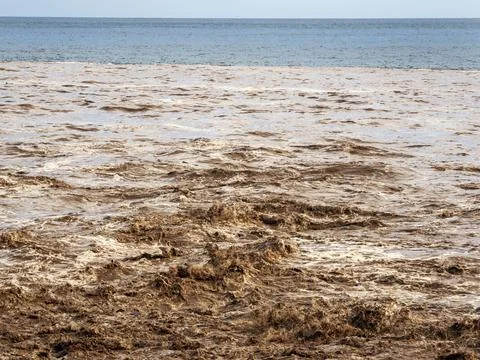 Eroded soil being washed into the sea down the Barrnaco de los Cocos Playa Sa Stock Photos