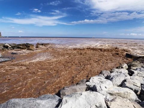 Eroded soil being washed into the sea down the Barrnaco de los Cocos Playa Sa Stock Photos