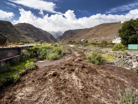 Eroded soil being washed into the sea down the Barrnaco de los Cocos Playa Sa Stock Photos
