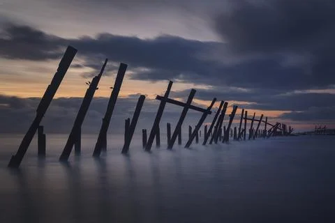 Eroded War time defences silhouetted under a dawn sky Stock Photos