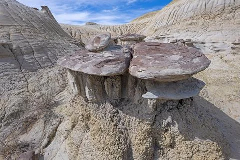 Eroding Capstone on a Muddy Base Foto stock