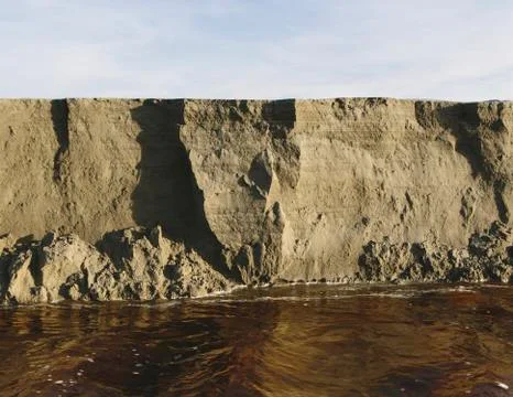 Eroding sand cliffs and fast moving water along intertidal area. Foto stock