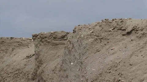 Eroding shoreline, sandy ridge at North Sea beach - pan Stock Footage 25847631